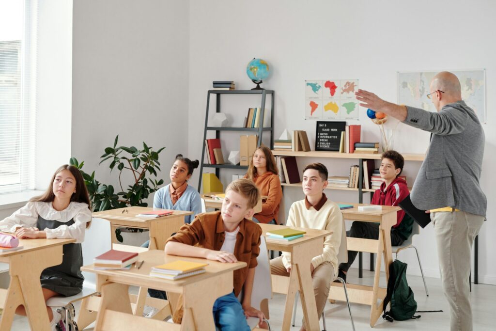 children sitting on a chair in front of a table