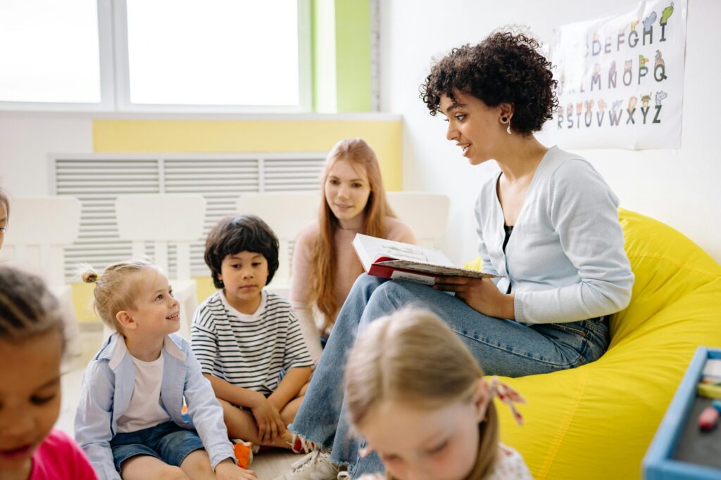 a woman reading a book to children
